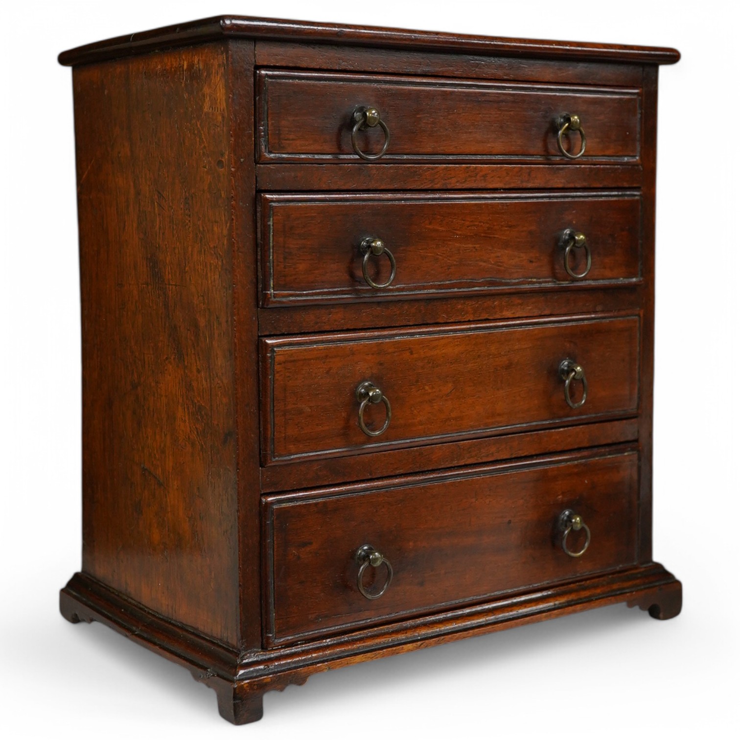 A late Georgian mahogany miniature four drawer chest. 23cm high, 21cm wide. Condition - good